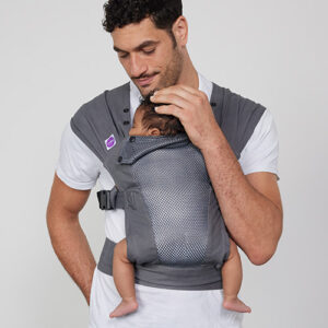 Man carries baby on his chest in Izmi Breeze Baby Carrier