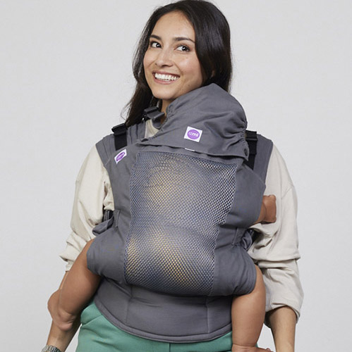 Woman carries toddler on her front in Izmi Breeze Toddler Carrier with Sleep Hood