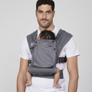 Man carries baby on his chest in Izmi Baby Carrier with Zip Pocket