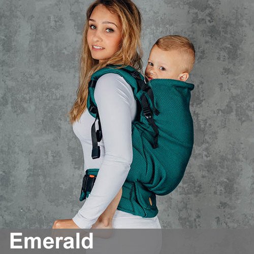 Woman carries toddler on her back in Lenny Lamb Preschool carrier in Emerald fabric, side view