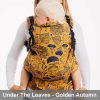 Woman carries toddler on her front in Lenny Lamb Preschool carrier in yellow Under the Leaves - Golden Autumn fabric