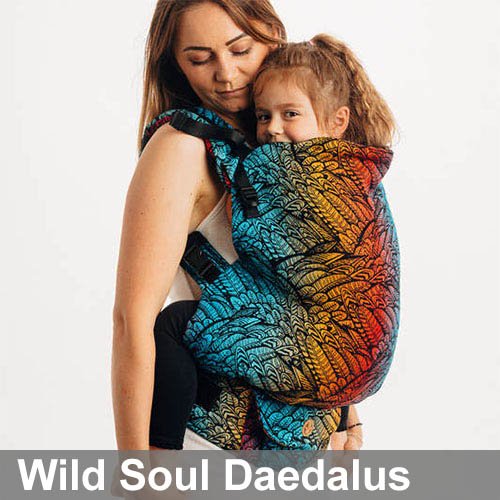 Woman carries toddler on her front in Lenny Lamb Preschool carrier in Wild Soul Daedalus fabric