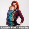 Woman carries baby facing towards her in the Lenny Lamb LennyUpgrade Baby Carrier in multicolour dinosaur print Jurassic Park New Era fabric