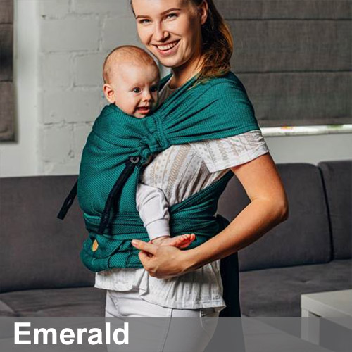 Woman carrying baby on her front in Lenny Lamb Lenny Hybrid Half Buckle Baby Carrier in Emerald, side view