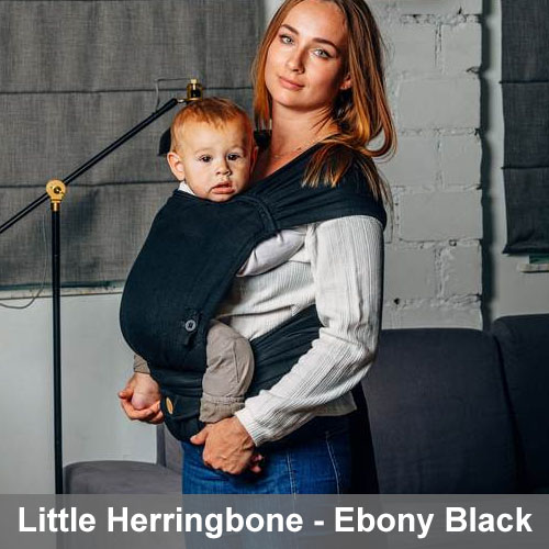 Woman carrying baby on her front in Lenny Lamb Lenny Hybrid Half Buckle Baby Carrier in Little Herringbone Ebony Black