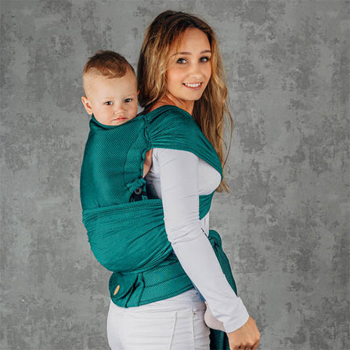 Woman carries toddler on her back in Lenny Lamb LennyHybrid Preschool toddler carrier in Emerald, side view