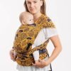 Woman carrying baby on her front in Lenny Lamb Lenny Hybrid Half Buckle Baby Carrier in Under the Leaves Golden Autumn