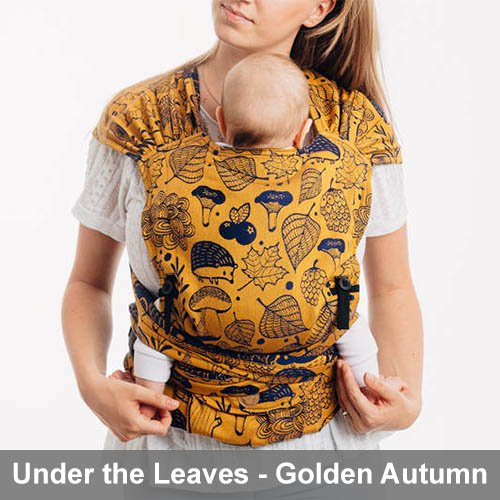 Woman carrying baby on her front in Lenny Lamb Lenny Hybrid Half Buckle Baby Carrier in Under the Leaves Golden Autumn