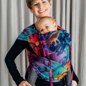 Woman carrying baby in Lenny Lamb Wrap Tai baby carrier in Jurassic Park New Era dinosaur fabric