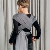 Back view of woman carrying baby in Lenny Lamb Wrap Tai baby carrier in Little Herringbone Ombre Grey fabric