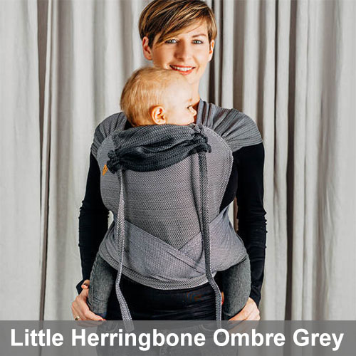 Woman carrying baby in Lenny Lamb Wrap Tai baby carrier in Little Herringbone Ombre Grey fabric