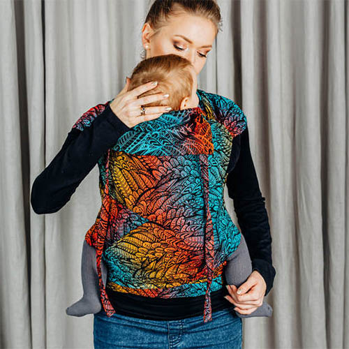 Woman carrying baby in Lenny Lamb Wrap Tai baby carrier in Wild Soul Daedalus fabric, front view