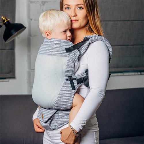 Woman carrying baby facing towards her in Lenny Lamb LennyUpgrade mesh baby carrier in grey Selenite fabric