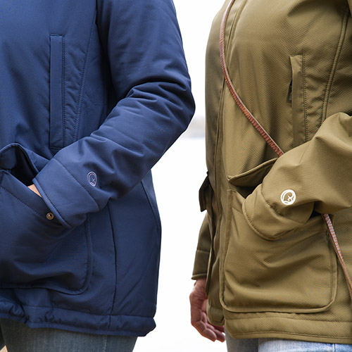 Close up showing two women wearing the Mamalila Cosy Allrounder babywearing coat in Navy and Khaki