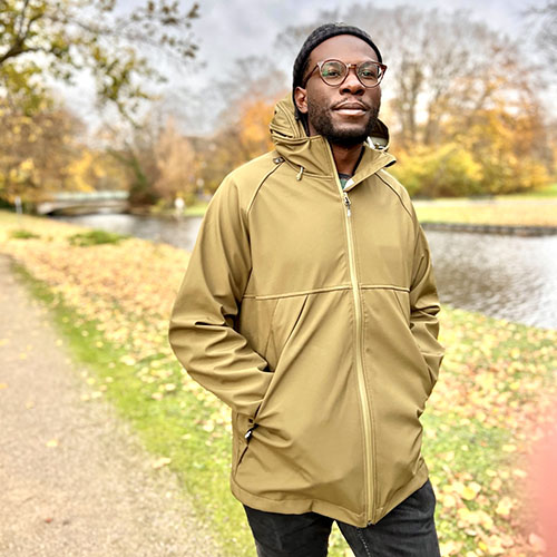 Man wears the Mamalila Mens Softshell Allrounder babywearing jacket in khaki